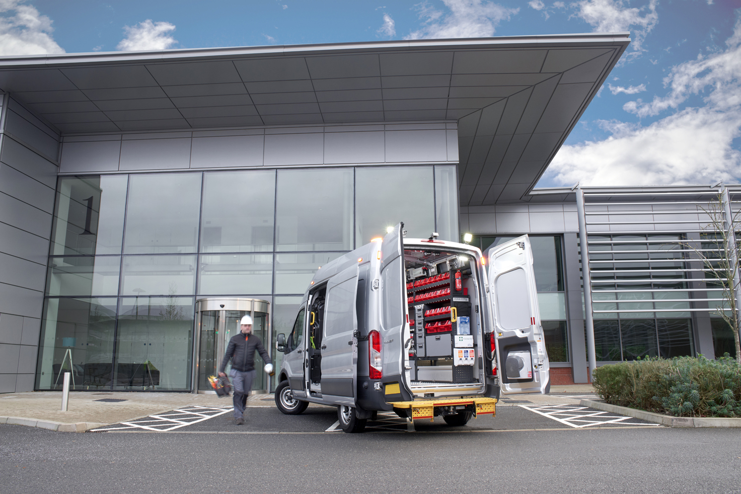 Plumber's van fitted out with modul-system van racking in a parking space