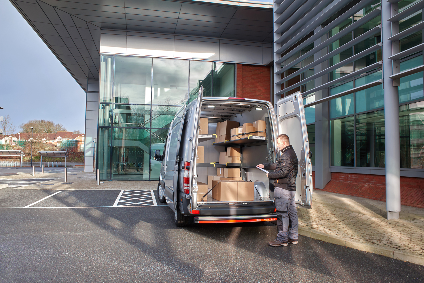 Delivery driver's van fitted out with modul-express van shelving