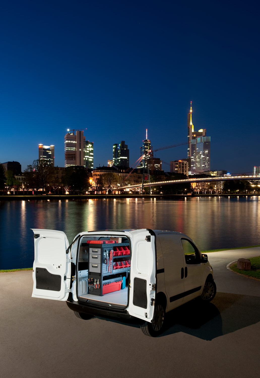 Van fitted out with modul-system van racking parked next to a river