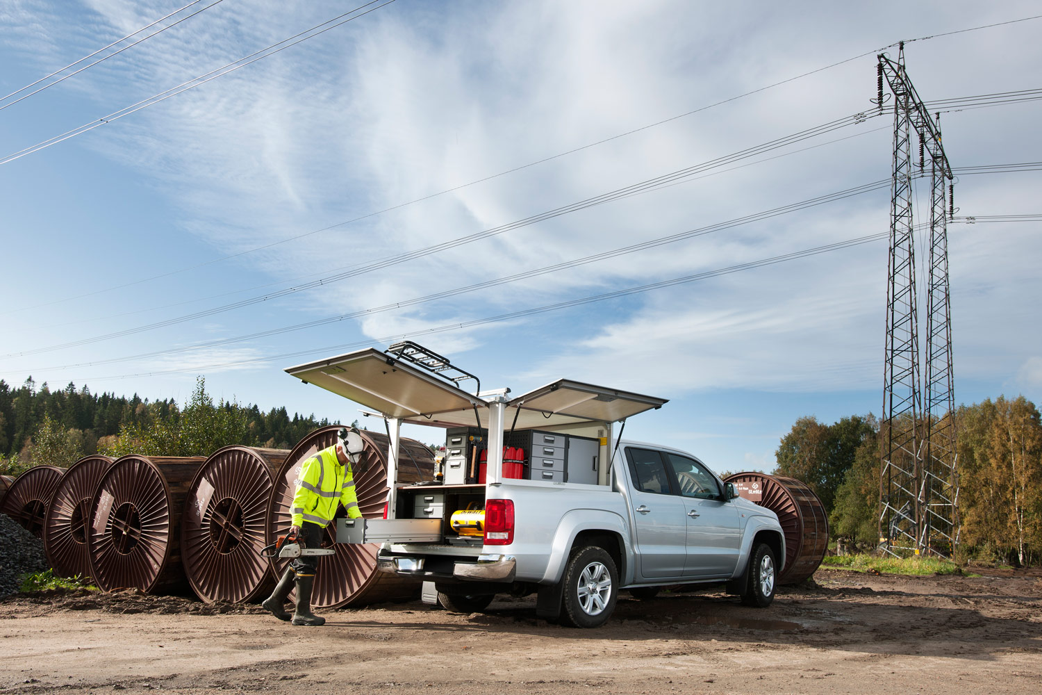 Worker's silver pickup truck with modul-system shelving on the job